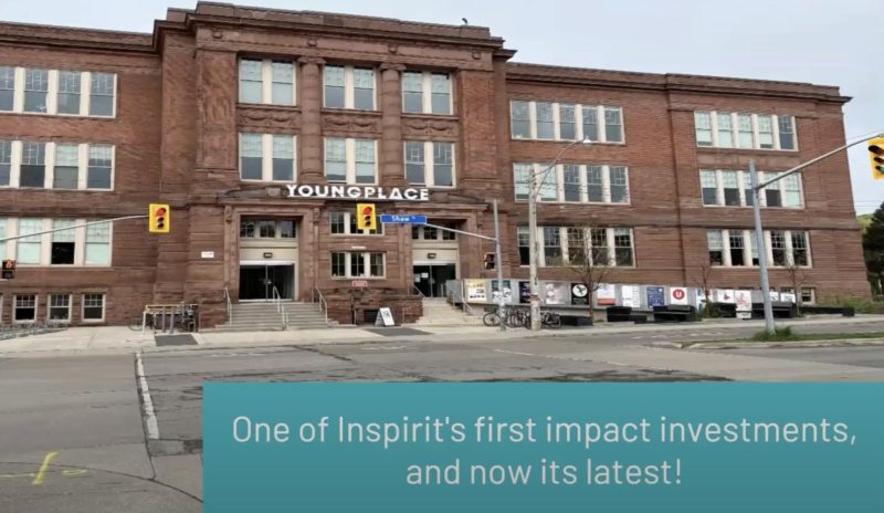 Blended Finance Webinar Series Screenshot from the Blended Finance Webinar, showing the exterior of a large red-brick building labeled 'Youngplace' at a city intersection, with text overlay reading 'One of Inspirit's first impact investments, and now its latest!